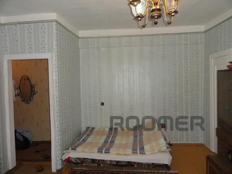 furniture in the room, a spacious bed, modern table with a T
